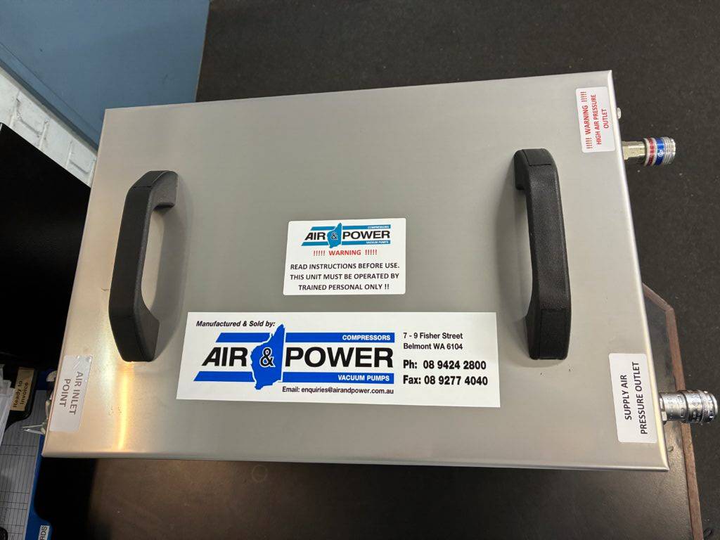 Air & Power technician working on compressed air system at job site